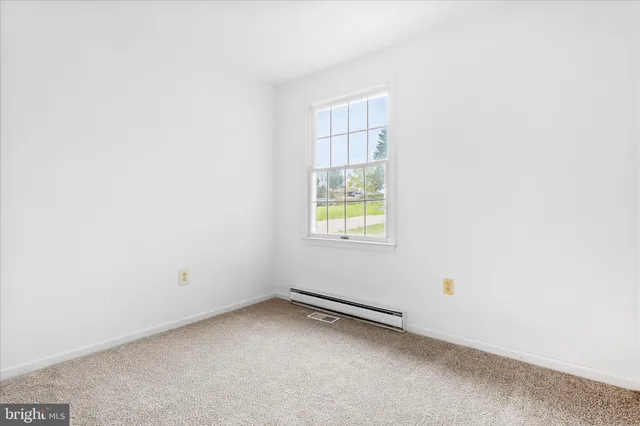 a view of an empty room and wooden floor