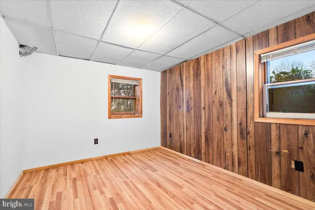 a view of a house with a yard and potted plants