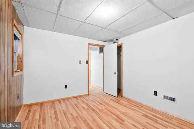 a view of a house with a yard and trees