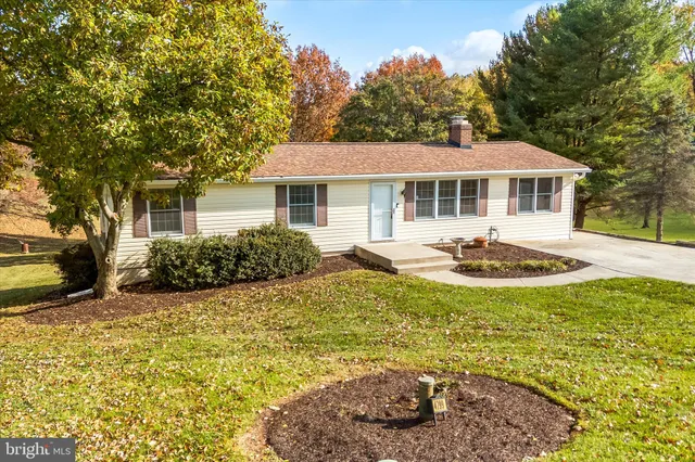 a view of a house with swimming pool and sitting area