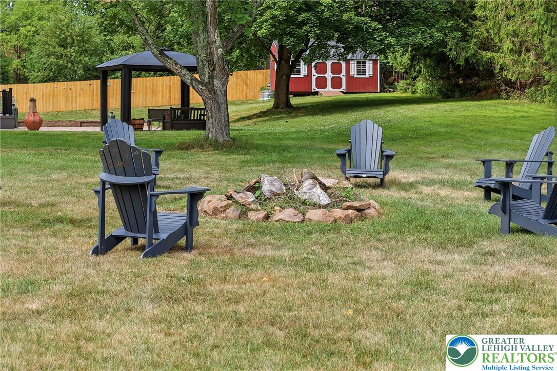 1553 Surrey Road Bethlehem, PA 18015 - Photo 88 of 92 Gather around the fire pit for cozy evenings under the stars in this private yard with a charming gazebo.