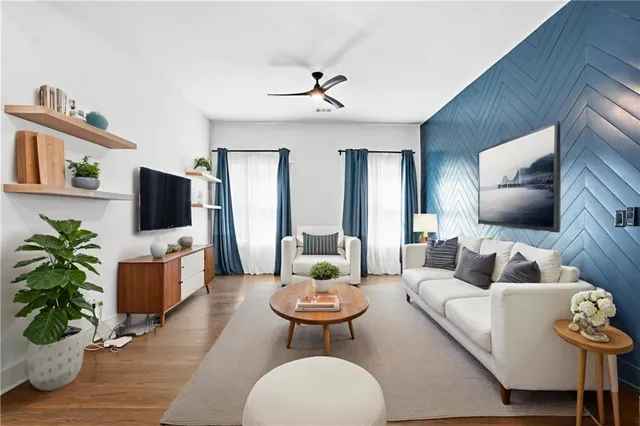 a living room with furniture and a flat screen tv