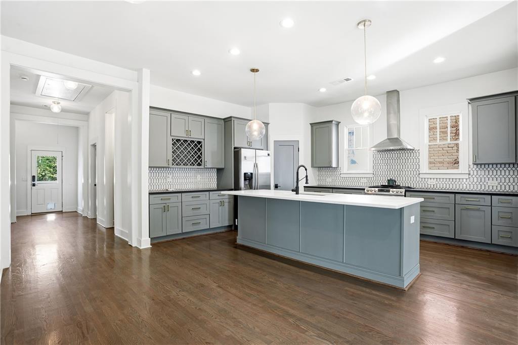 1025 Oak Street Southwest Atlanta, GA 30310 - Photo 14 of 30 a large kitchen with cabinets wooden floor and stainless steel appliances