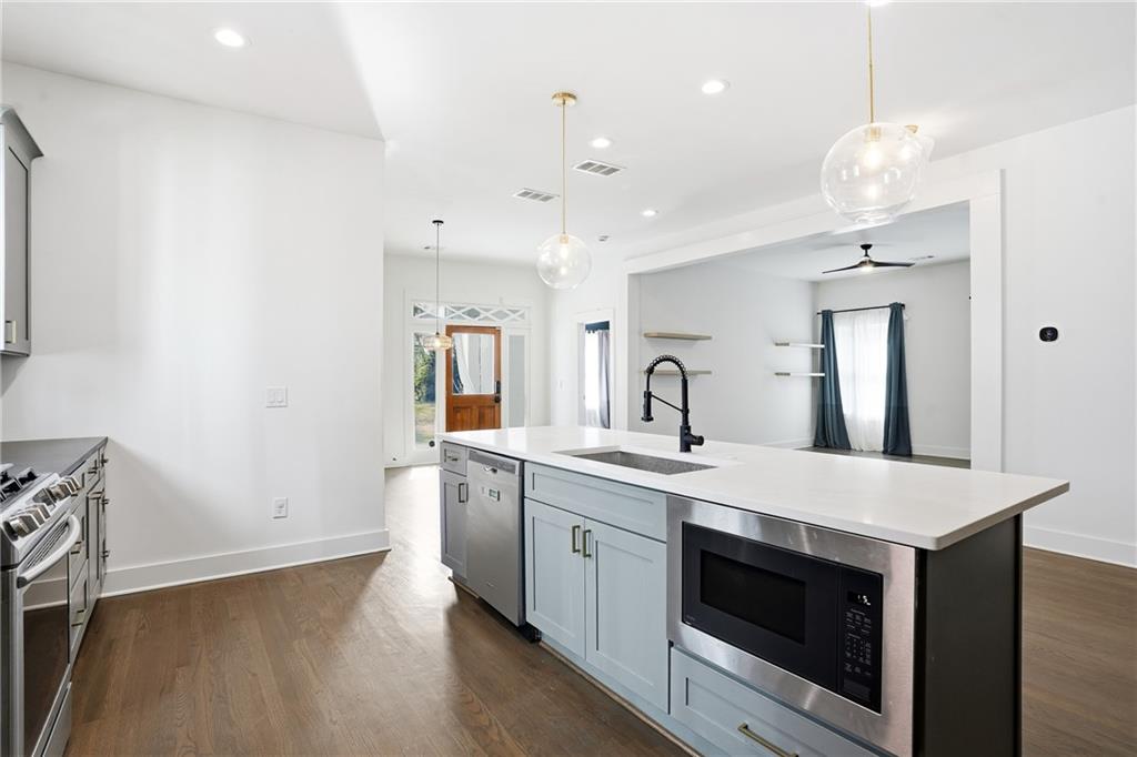 1025 Oak Street Southwest Atlanta, GA 30310 - Photo 15 of 30 a large kitchen with a stove and a sink