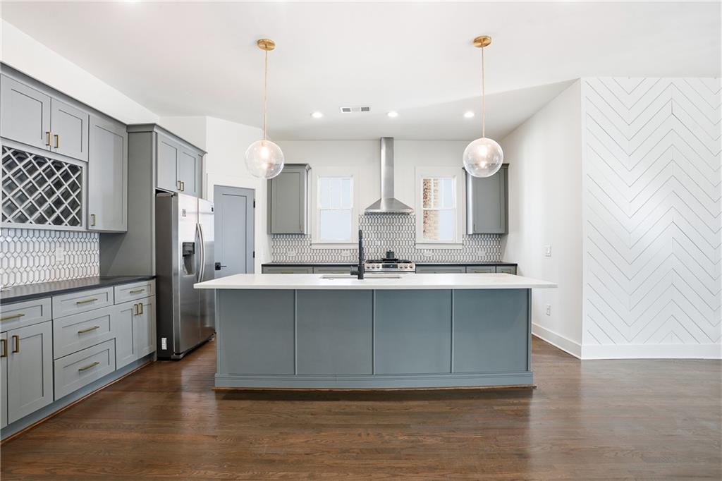 1025 Oak Street Southwest Atlanta, GA 30310 - Photo 16 of 30 a large kitchen with stainless steel appliances a large counter top a sink a stove and a refrigerator
