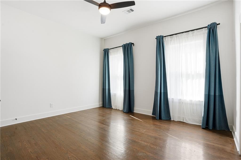 1025 Oak Street Southwest Atlanta, GA 30310 - Photo 17 of 30 an empty room with wooden floor and windows