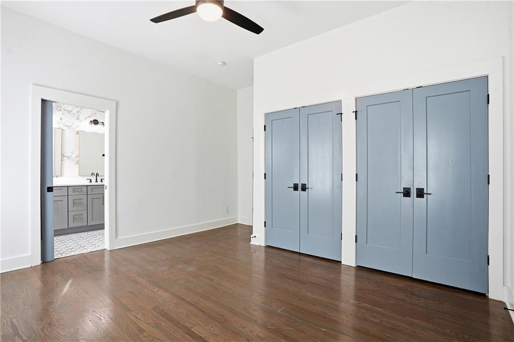 1025 Oak Street Southwest Atlanta, GA 30310 - Photo 18 of 30 an empty room with wooden floor cabinet and ceiling fan