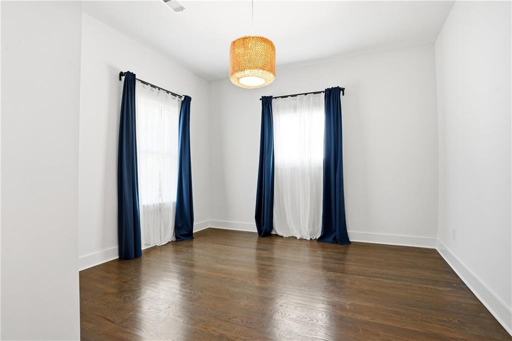 1025 Oak Street Southwest Atlanta, GA 30310 - Photo 20 of 30 an empty room with wooden floor and mirror