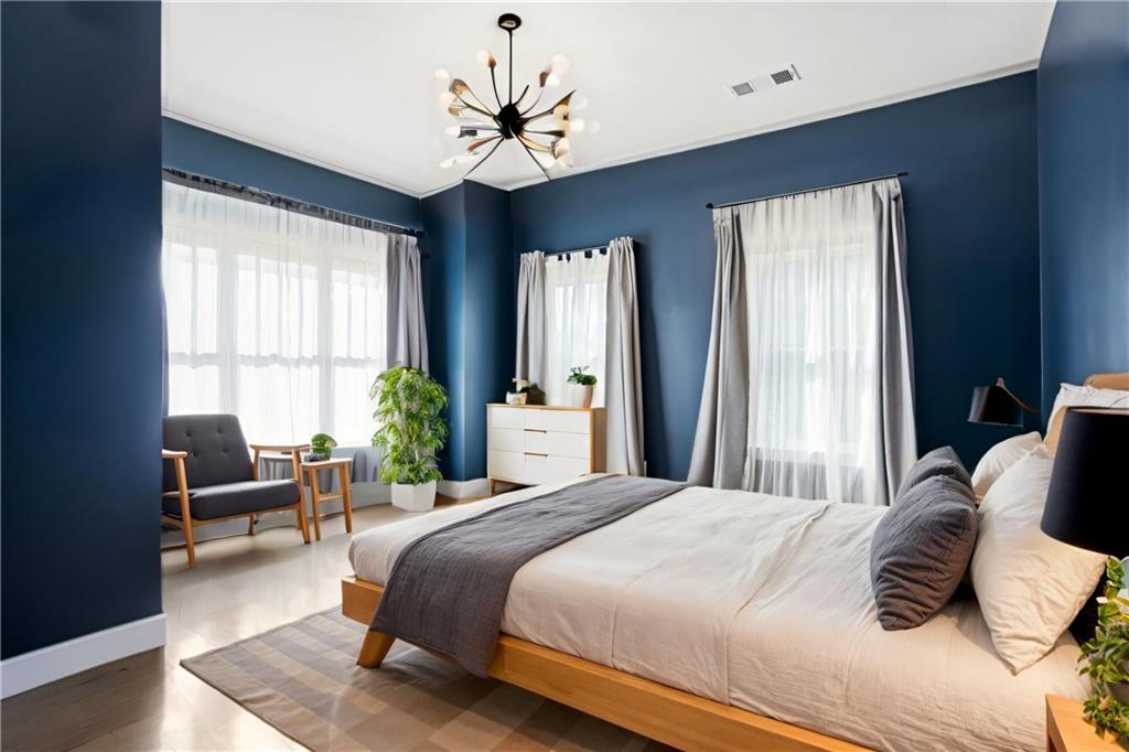 1025 Oak Street Southwest Atlanta, GA 30310 - Photo 3 of 30 a bedroom with a large bed and a chandelier