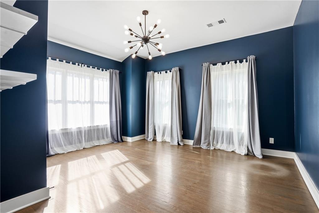 1025 Oak Street Southwest Atlanta, GA 30310 - Photo 8 of 30 an empty room with wooden floor and windows