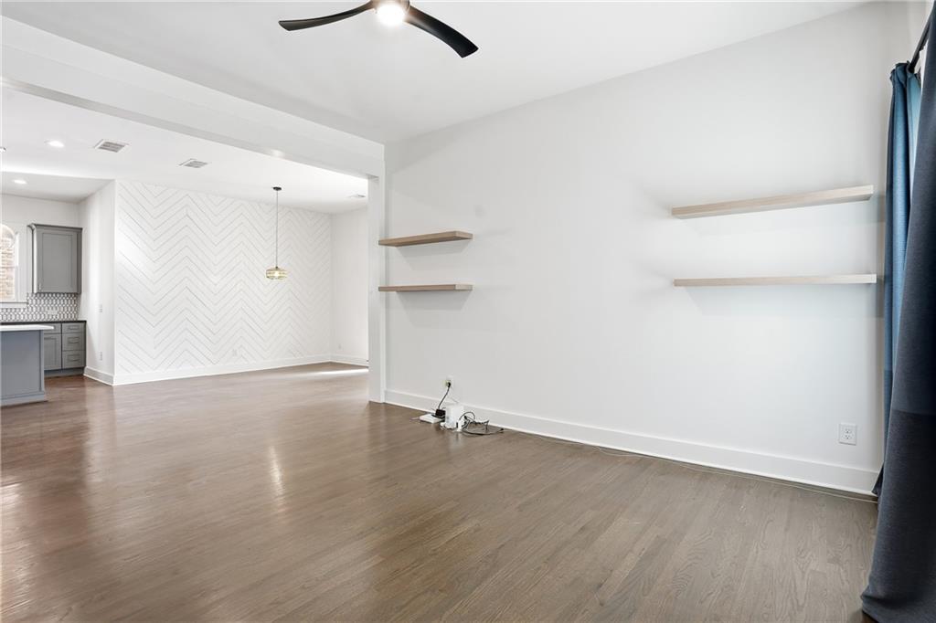 1025 Oak Street Southwest Atlanta, GA 30310 - Photo 10 of 30 an empty room with wooden floor and windows