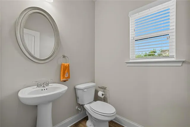a bathroom with a toilet a sink and a mirror