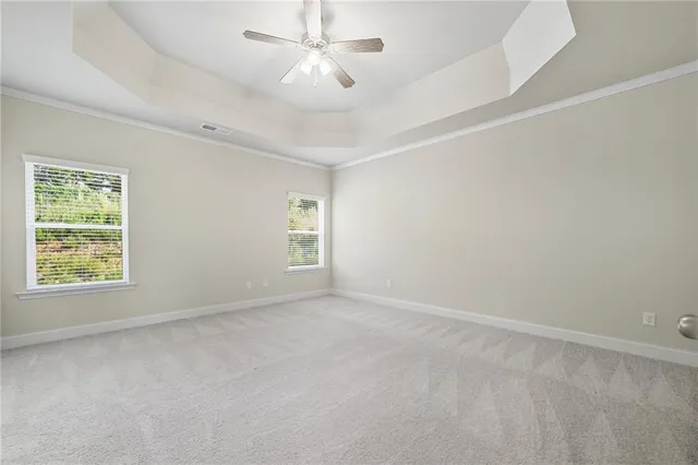 an empty room with a window and a ceiling fan
