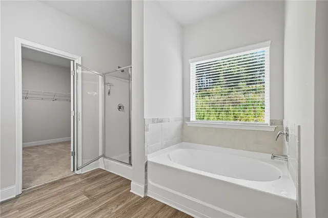 a bathroom with a bathtub and a shower