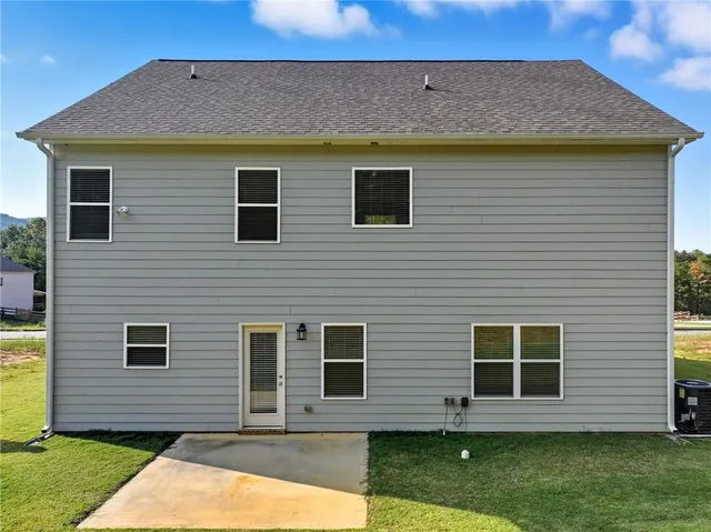 a view of a house with a backyard