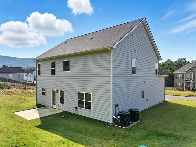 a view of a house with a backyard