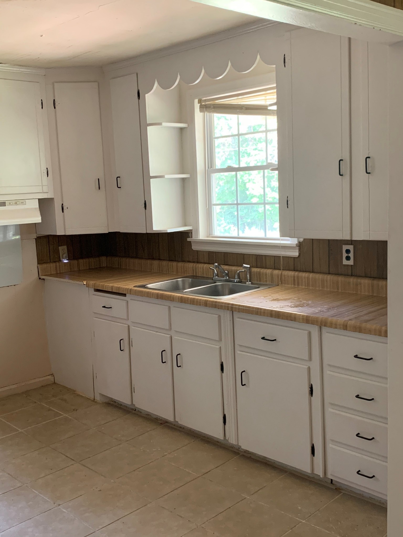 6339 Roy Pearson Road Springfield, TN 37172 - Photo 8 of 9 a kitchen with granite countertop white cabinets sink and window