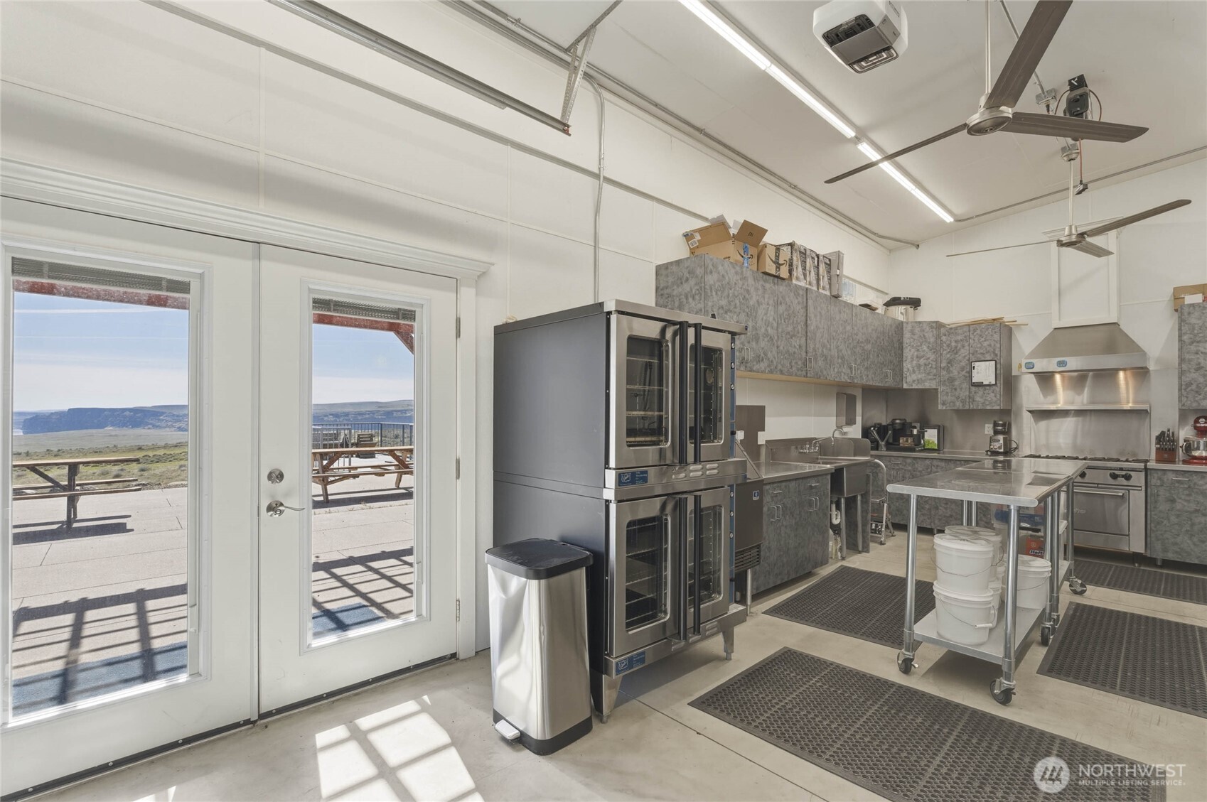 117 Freese Road Quincy, WA 98848 - Photo 32 of 40 a kitchen with stainless steel appliances kitchen island granite countertop a refrigerator and cabinets