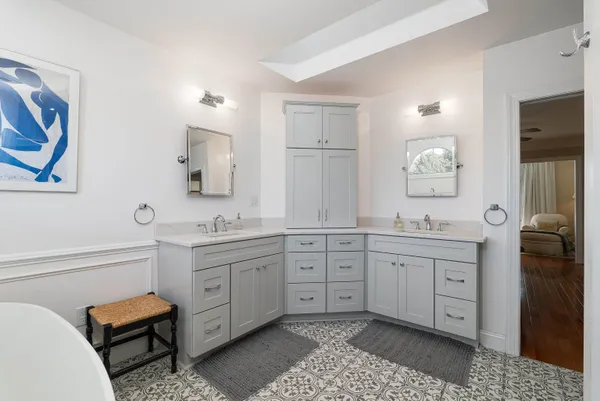 a en suite bathroom with a double vanity sink and a mirror
