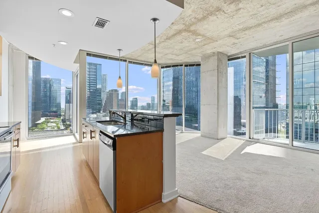 a kitchen with stainless steel appliances granite countertop a stove and a refrigerator