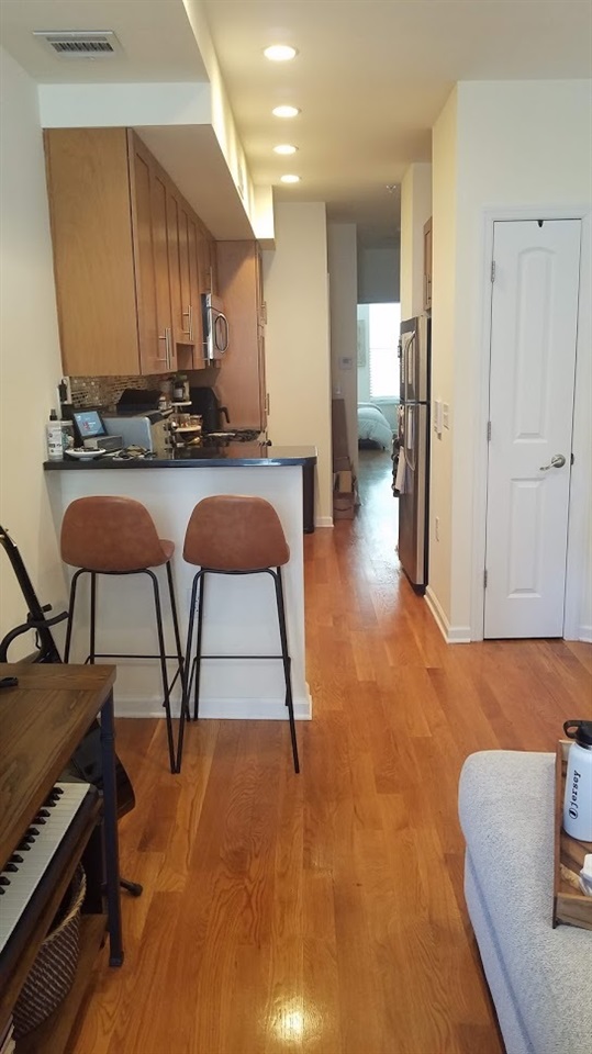 525 Adams Street, Unit 4L Hoboken, NJ 07030 - Photo 4 of 7 a living room with furniture and a wooden floor