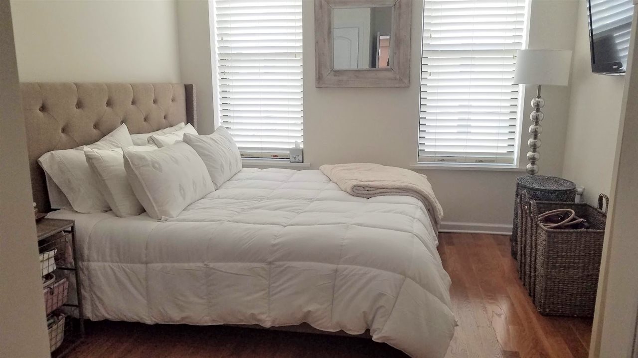 525 Adams Street, Unit 4L Hoboken, NJ 07030 - Photo 6 of 7 a bedroom with a bed and a window