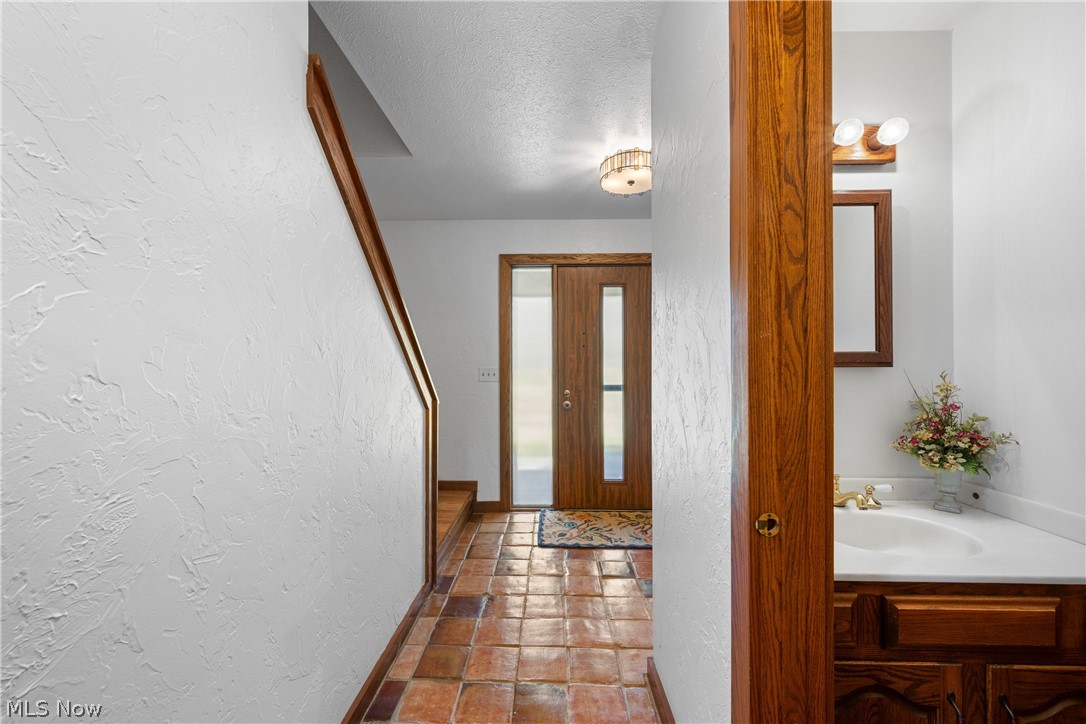 490 Johnson Road Kent, OH 44240 - Photo 20 of 49 Half bath off hallway connecting the entry foyer to the kitchen area of the home.