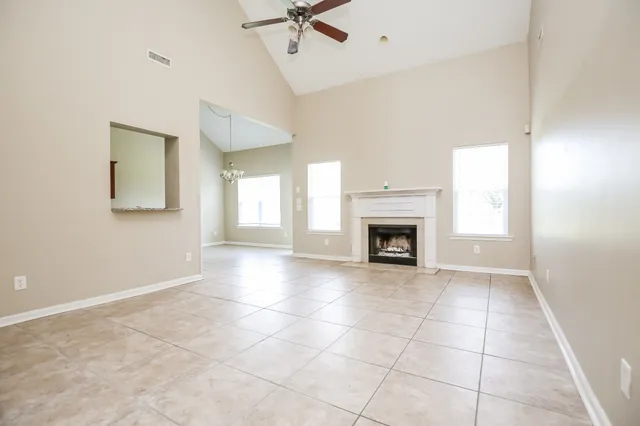 a view of an empty room with a fireplace and a window