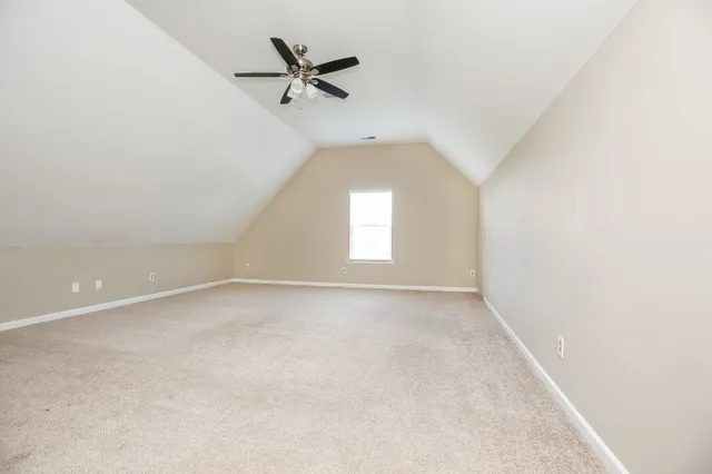 an empty room with a empty space and windows