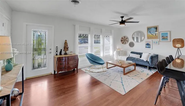 a living room with furniture and wooden floor