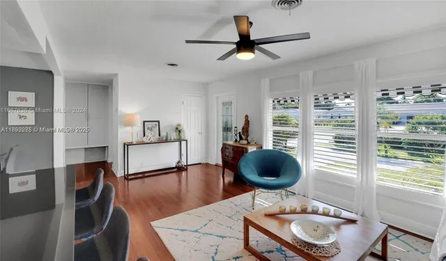 a living room with furniture a rug and a window