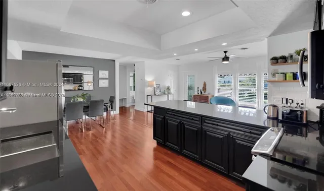 a large kitchen with lots of counter space and stainless steel appliances