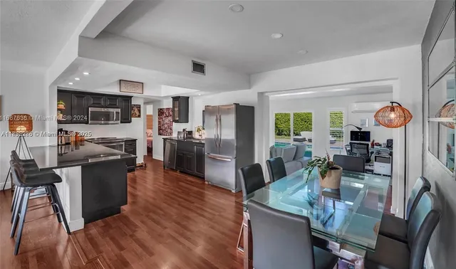 a large kitchen with a table and chairs in it