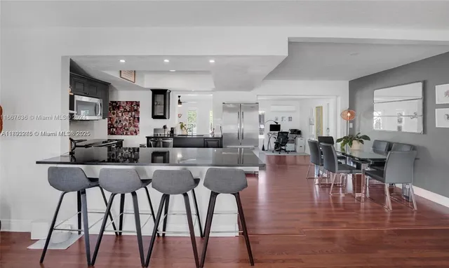 a view of a dining room with furniture and wooden floor