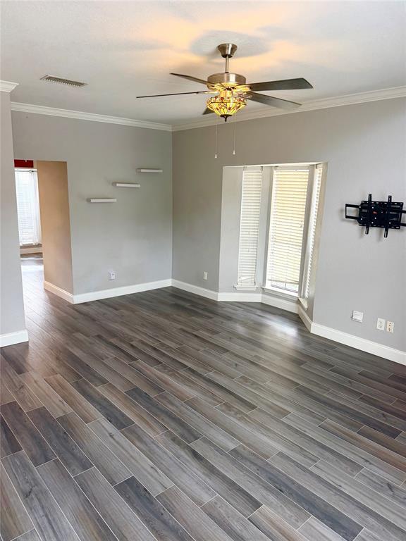 14333 Preston Road, Unit 806 Dallas, TX 75254 - Photo 5 of 17 Wood-look plank flooring throughout, ceiling fan with integrated lighting, bay window with louvered blinds, and crown molding