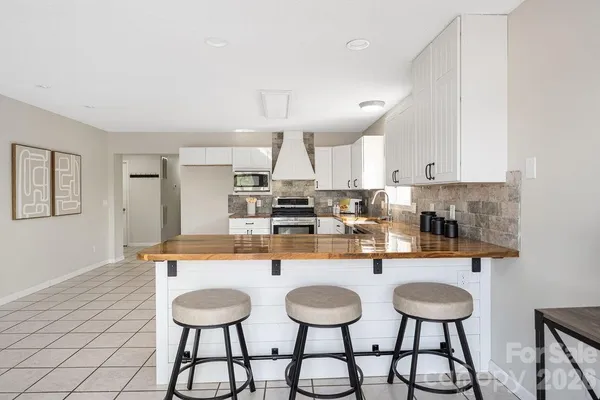 a kitchen with stainless steel appliances a sink and stove