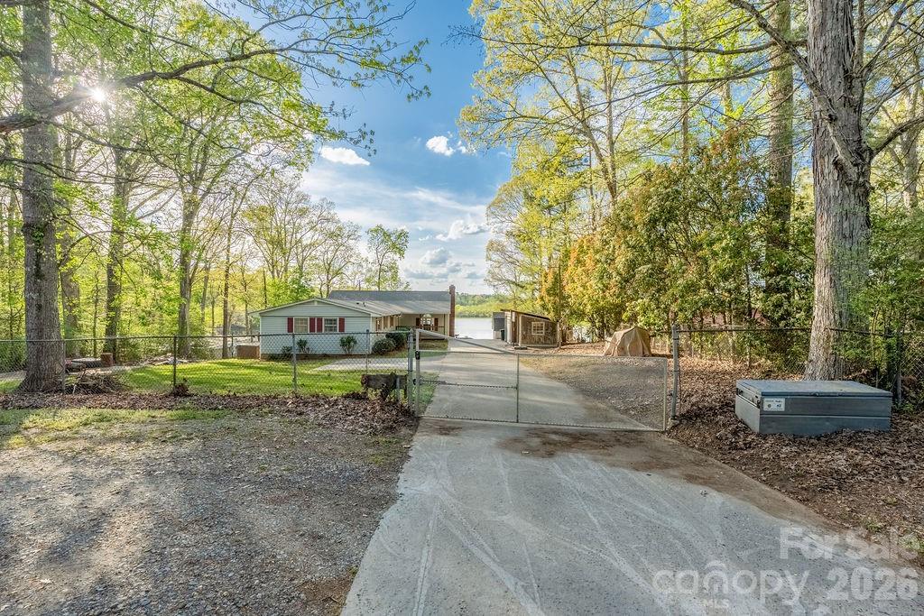 349 Lake Wylie Road Belmont, NC 28012 - Photo 2 of 48 a view of backyard of house with green space
