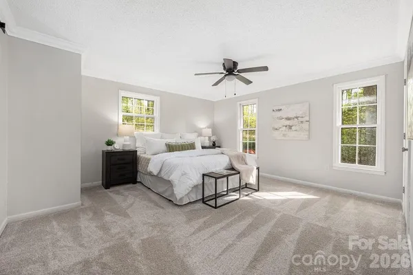 a spacious bedroom with a bed and a window