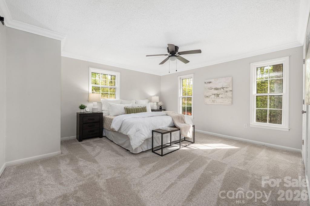 349 Lake Wylie Road Belmont, NC 28012 - Photo 25 of 48 a spacious bedroom with a bed and a window