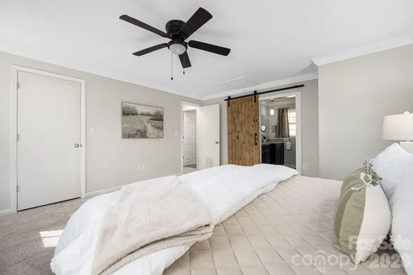 a bedroom with a large bed and a window