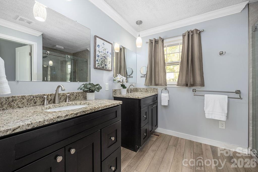 349 Lake Wylie Road Belmont, NC 28012 - Photo 28 of 48 a bathroom with a granite countertop sink double vanity and a mirror