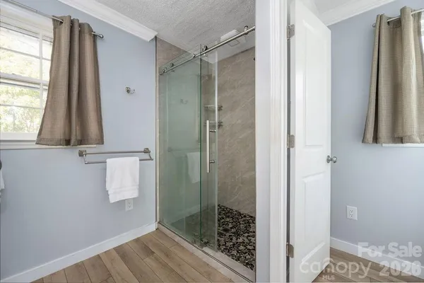 a bathroom with a shower and a sink