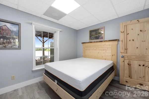 a bed sitting in a bedroom next to a window