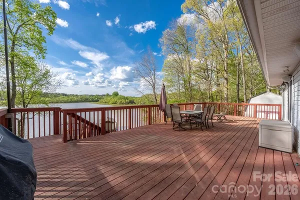 a view of a patio with table and chairs and wooden floor