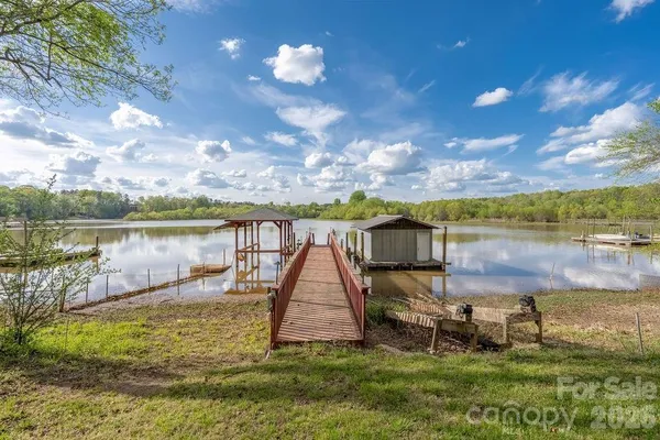 a view of a lake with houses in the back