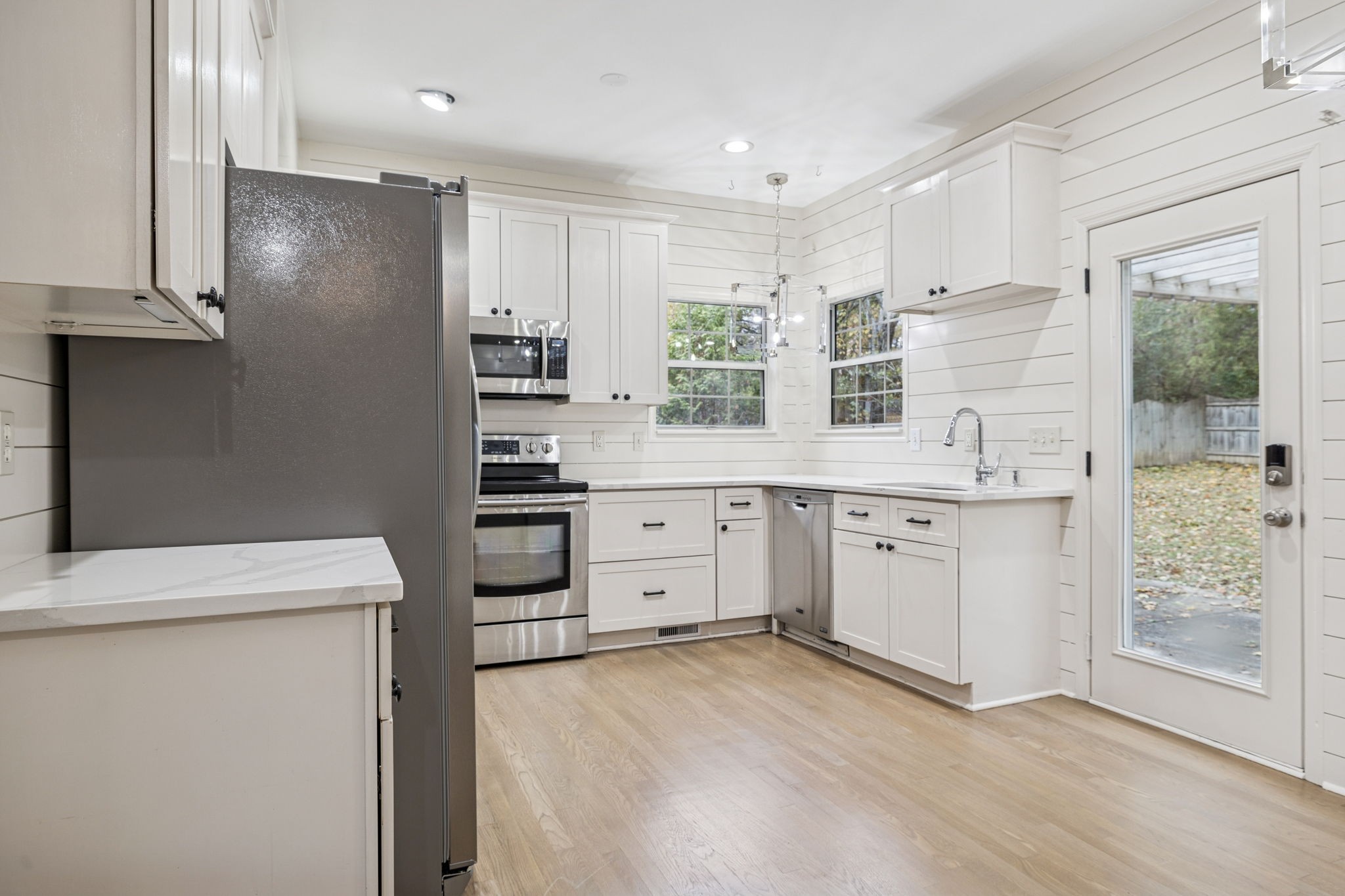 5244 Beech Ridge Road Nashville, TN 37221 - Photo 20 of 77 a kitchen with white cabinets and white appliances