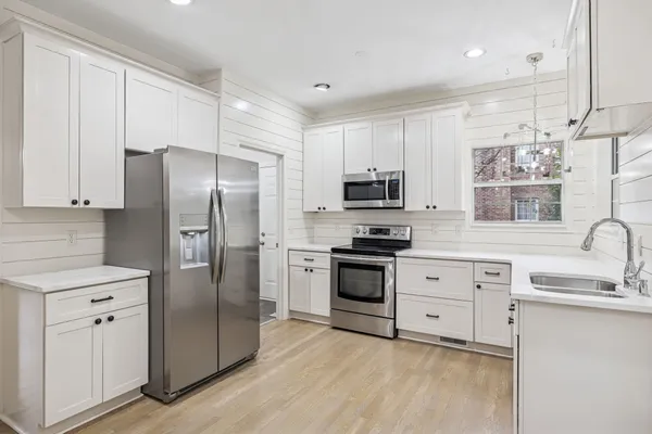 a view of a kitchen with cabinets and a sink