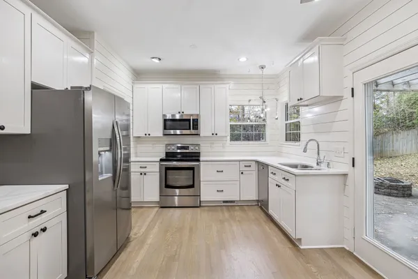 a utility room with cabinets dryer and washer