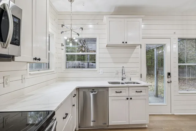 a white toilet sitting next to a shower