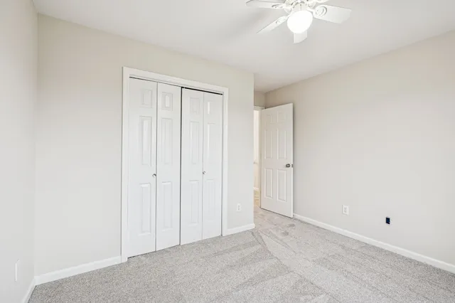a view of a yard with wooden fence and a large tree